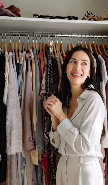 happy woman smiling in her walk-in closet organized by Eclat245